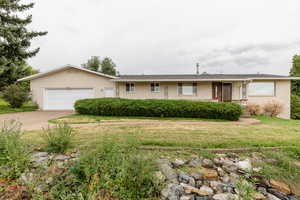 Ranch-style house with a front lawn and a garage