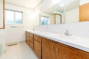 Bathroom with tile patterned floors and vanity