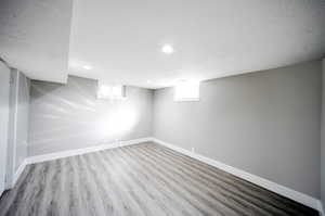 Basement bedroom with light wood-style floors