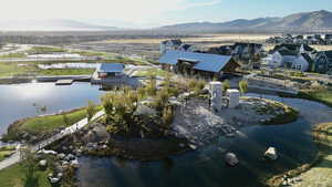 Birds eye view of property with a water and mountain view