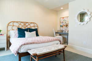 Bedroom with carpet floors and vaulted ceiling