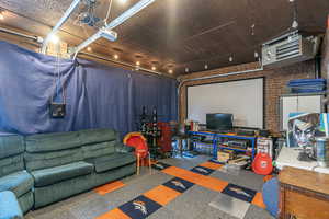 Playroom featuring brick wall and carpet flooring