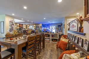 Dining room with dark hardwood / wood-style flooring