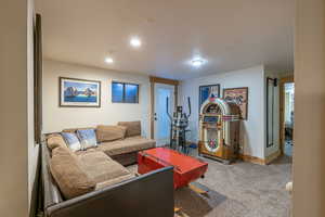 Carpeted living room featuring a textured ceiling