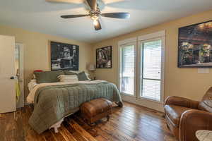 Bedroom featuring dark hardwood / wood-style flooring and ceiling fan