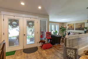 Foyer entrance with hardwood / wood-style floors and french doors