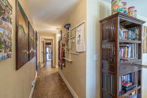 Corridor with hardwood / wood-style flooring and lofted ceiling