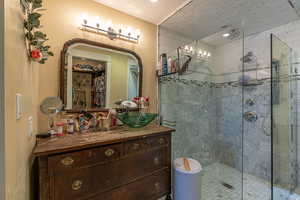 Bathroom featuring an enclosed shower and vanity