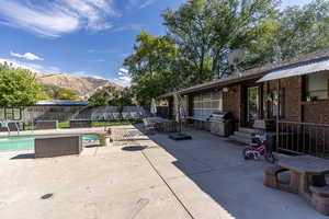 View of patio / terrace with a fenced in pool, a grill, and a mountain view