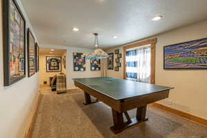 Playroom with a textured ceiling and carpet