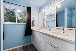 Bathroom featuring wood-type flooring, vanity, and a textured ceiling