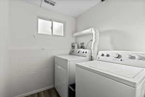 Laundry area featuring dark hardwood / wood-style floors and independent washer and dryer