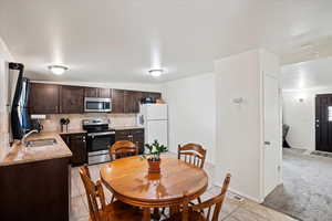 Tiled dining area featuring sink