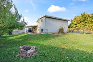 Rear view of house with a yard