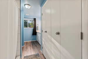 Hall with hardwood / wood-style flooring and a textured ceiling