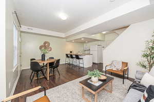 Living room featuring a textured ceiling and dark hardwood / wood-style flooring