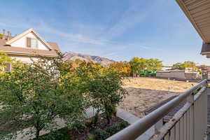 View of yard featuring a balcony and a mountain view