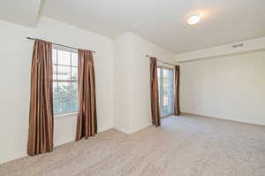 Spare room with light colored carpet