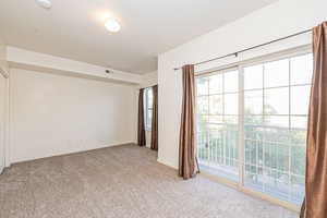 Unfurnished room featuring light colored carpet