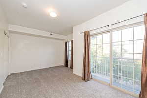 Unfurnished room featuring carpet floors and a textured ceiling