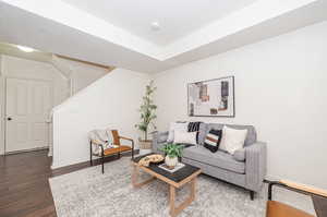 Living room with dark wood-type flooring