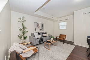 Living room featuring a textured ceiling and dark hardwood / wood-style flooring