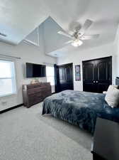 Bedroom featuring a ceiling fan, and light colored carpet