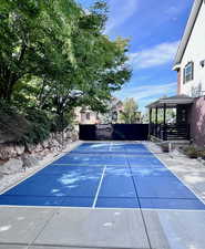 View of backyard with pickleball court