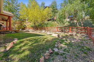 View of yard with a wooden deck