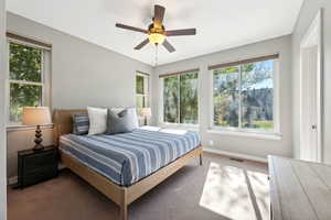 Bedroom featuring ceiling fan and carpet floors