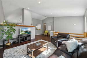 Living room with hardwood / wood-style flooring and lofted ceiling