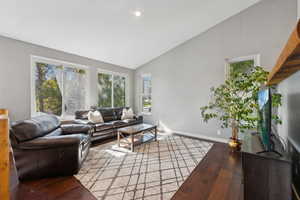 Living room featuring lofted ceiling and hardwood / wood-style floors