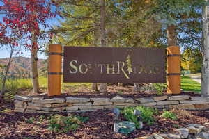 Community / neighborhood sign with a mountain view