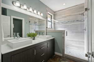 Bathroom featuring walk in shower and vanity