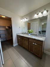 Bathroom featuring tile patterned flooring, vanity, and a textured ceiling