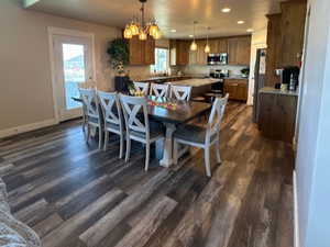 Dining area featuring a notable chandelier and dark hardwood / wood-style floors