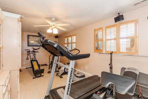 Exercise room featuring carpet floors and ceiling fan