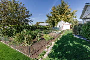 View of yard with a garage and an outbuilding