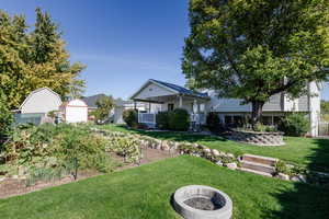 View of front of house featuring a front yard and a fire pit