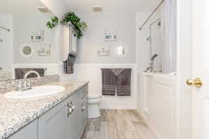 Full bathroom featuring toilet, vanity, and shower with separate bathtub