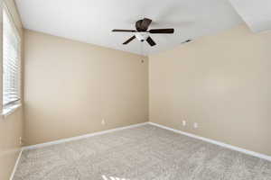 Spare room with ceiling fan and carpet floors