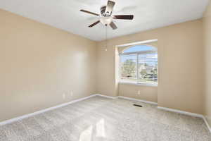 Unfurnished room featuring light carpet and ceiling fan