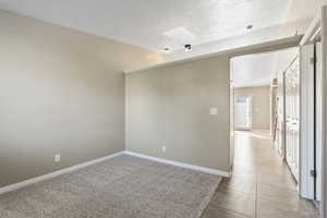 Spare room featuring a skylight and light colored carpet