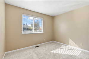 Spare room featuring carpet flooring