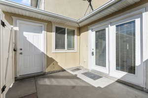 Doorway to property featuring a patio area