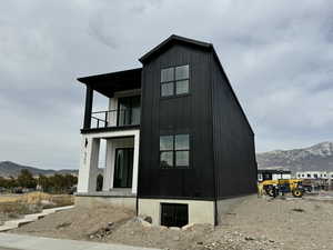 View of home's exterior featuring a balcony and a mountain view