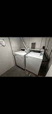 Laundry room with washing machine and clothes dryer