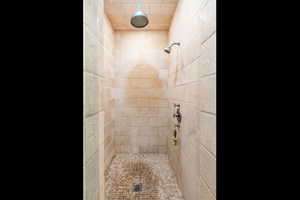 Bathroom featuring a tile shower