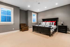 Bedroom featuring light carpet