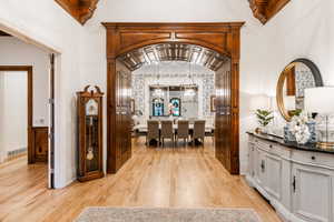 Interior space featuring light hardwood / wood-style flooring, a chandelier, and vaulted ceiling